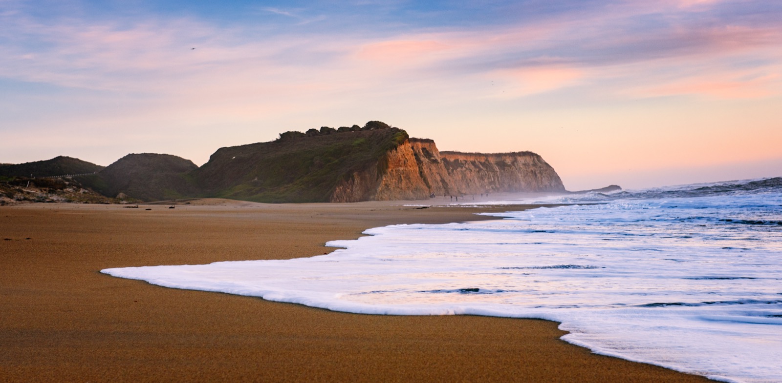 Coastal cliffs and surf at sunset, Northern California.